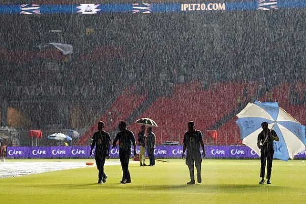 groundsmen-and-other-officials-walk-amid-rain-before-the-start. match GT vs KKR